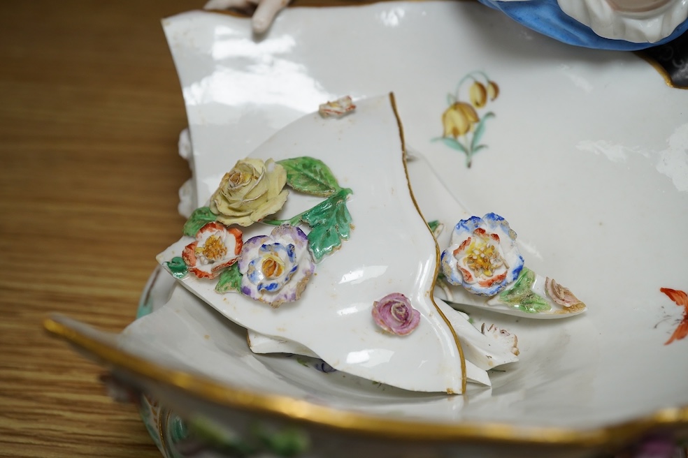 A Meissen female figural dish, 27cm wide. Condition - dish damaged (pieces in bag), crack near front knee